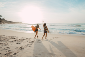 Two surfers heading to the ocean